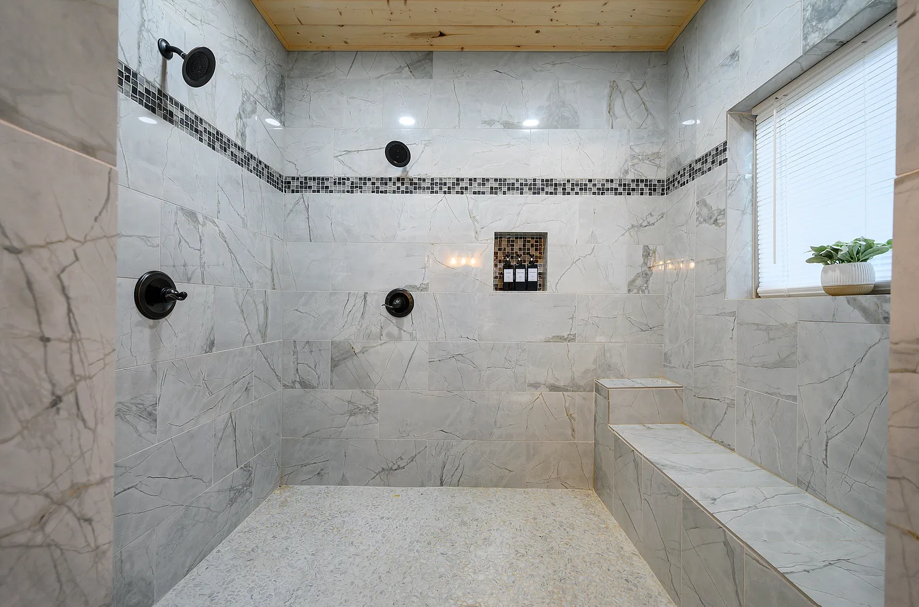 Oversized spa-style walk-in shower with elegant marble tilework