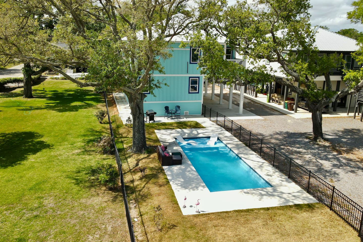 Imagine relaxing poolside in a private, tree-lined retreat near the beach.
