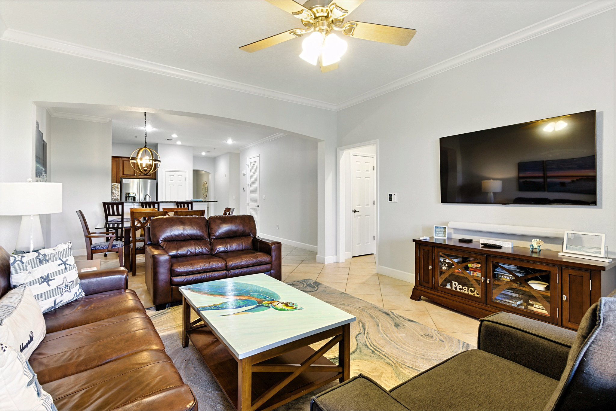 Your favorite gathering spot after the beach. 🐚📺
Stretch out on the comfy leather sofas, throw on a movie on the big-screen TV, and let the open living space keep everyone connected—from the kitchen to the dining table to the relaxing lounge area.
