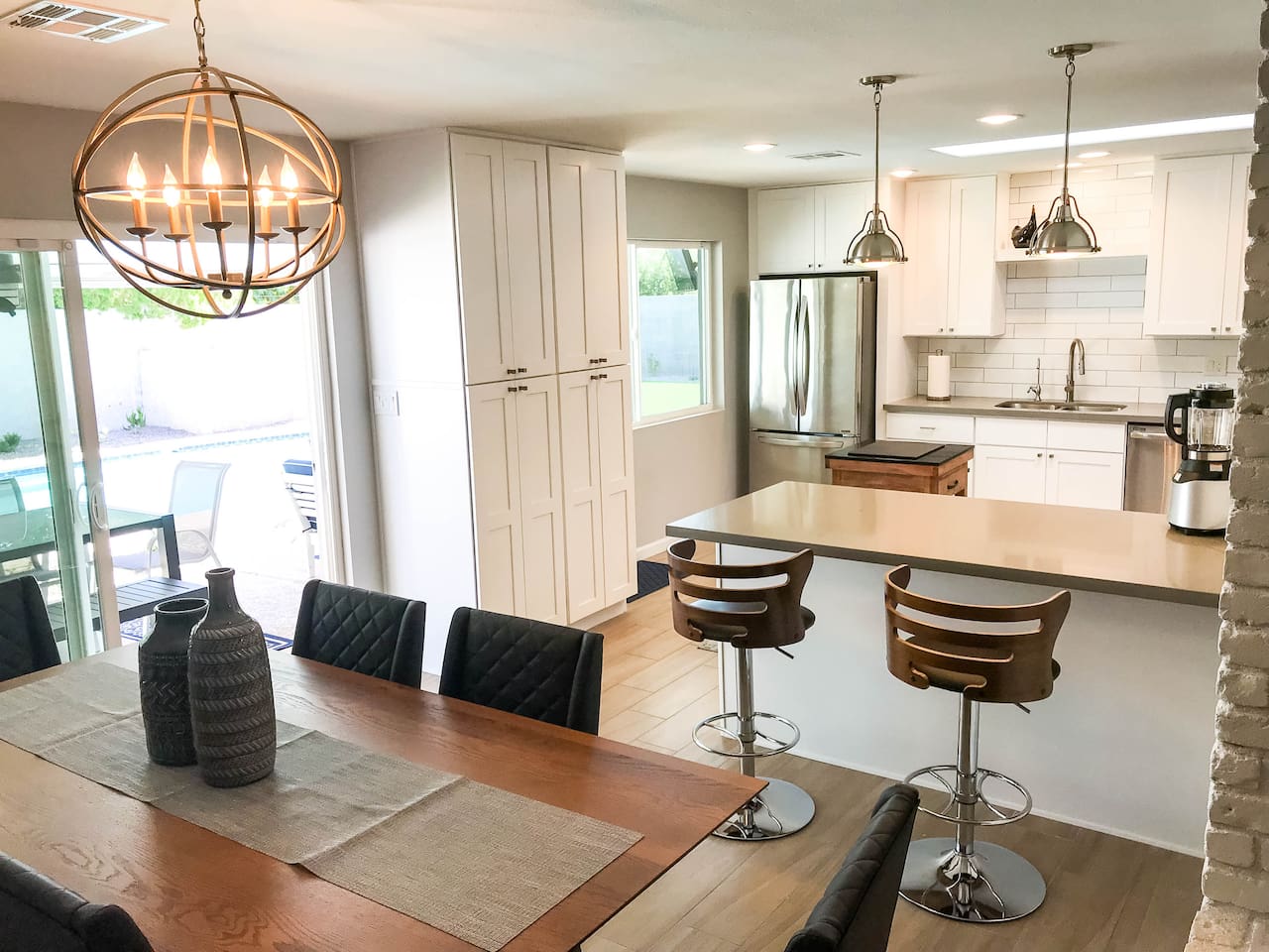 Bright airy kitchen with windows, sliders, and sky light.