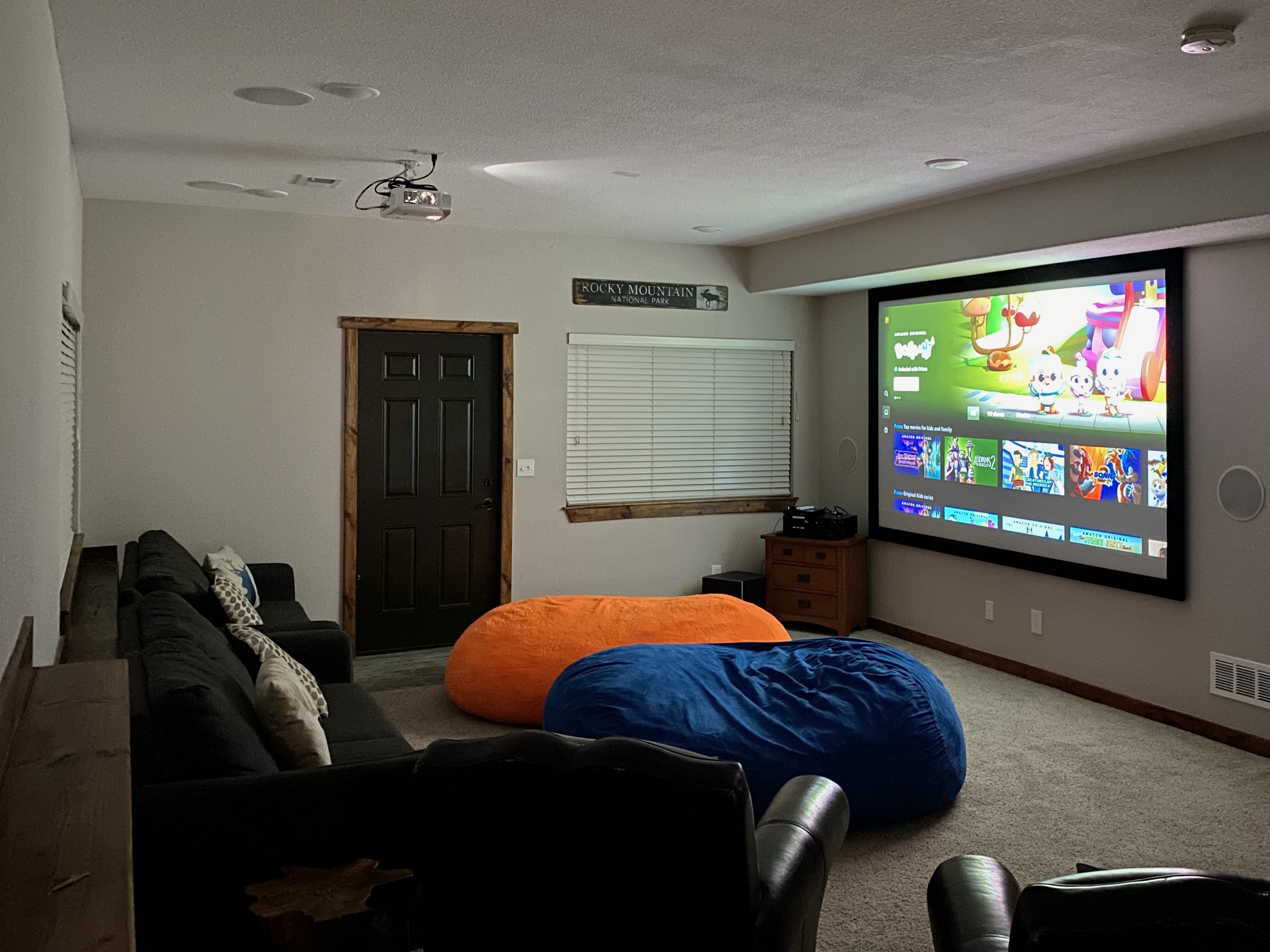 Share family Roku movie night in the lower level with theater room with a projector.
