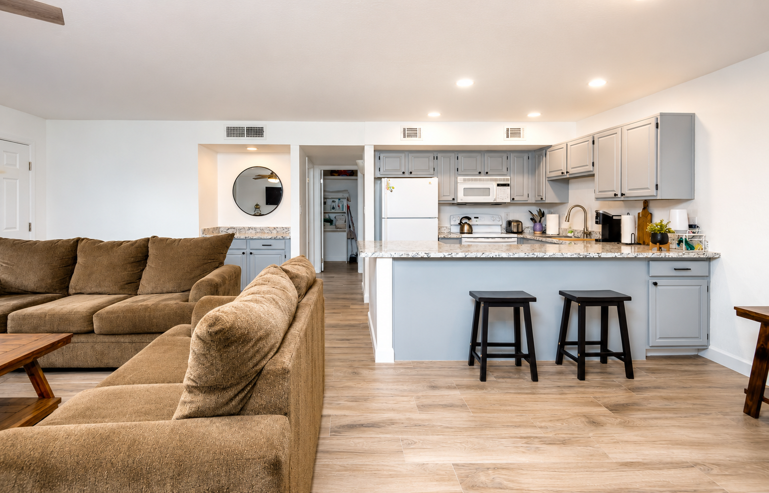 Living room with comfy seating, kitchen bar seating, and an open layout for easy meals and downtime.
