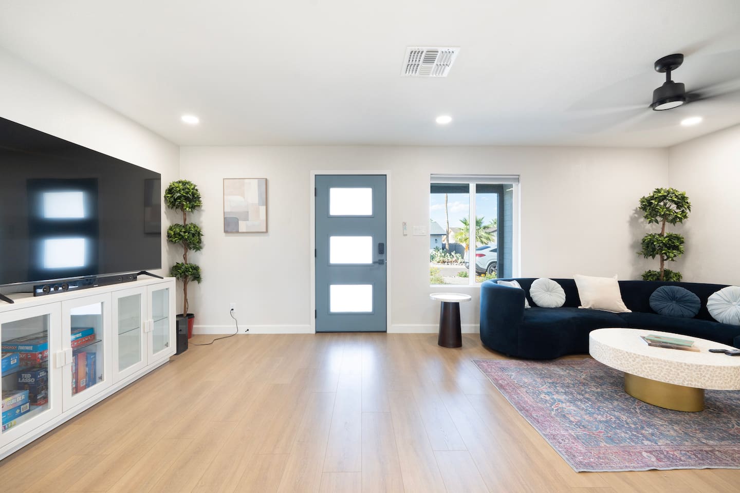 Bright, open living room with smart TV, designer seating, and plenty of space to relax and unwind