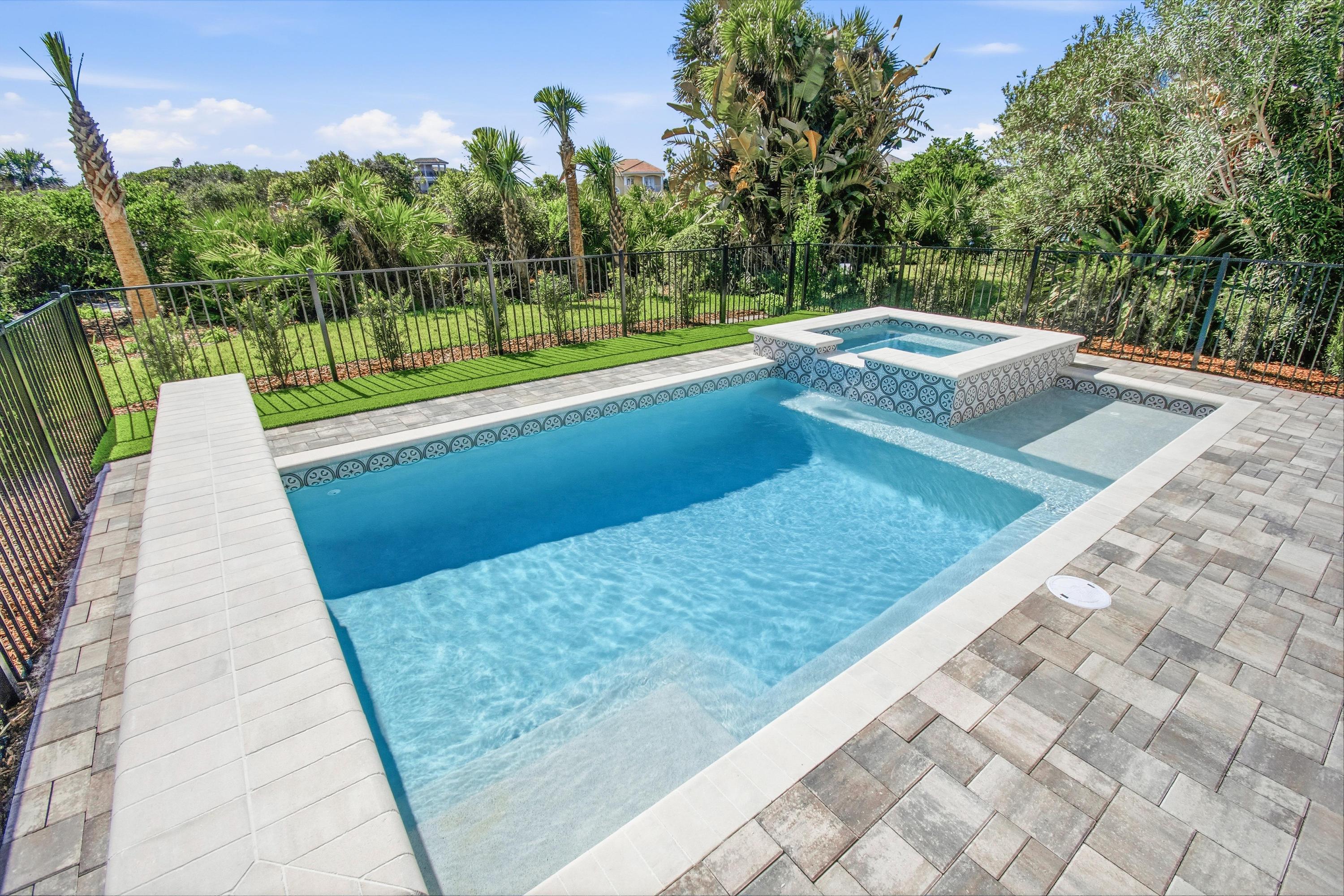 Your own pocket oasis: cool off in the sparkling pool, then sink into the raised spa while lush greenery keeps it private. Afternoon plans? Just breathe, float, and let time slow down.
