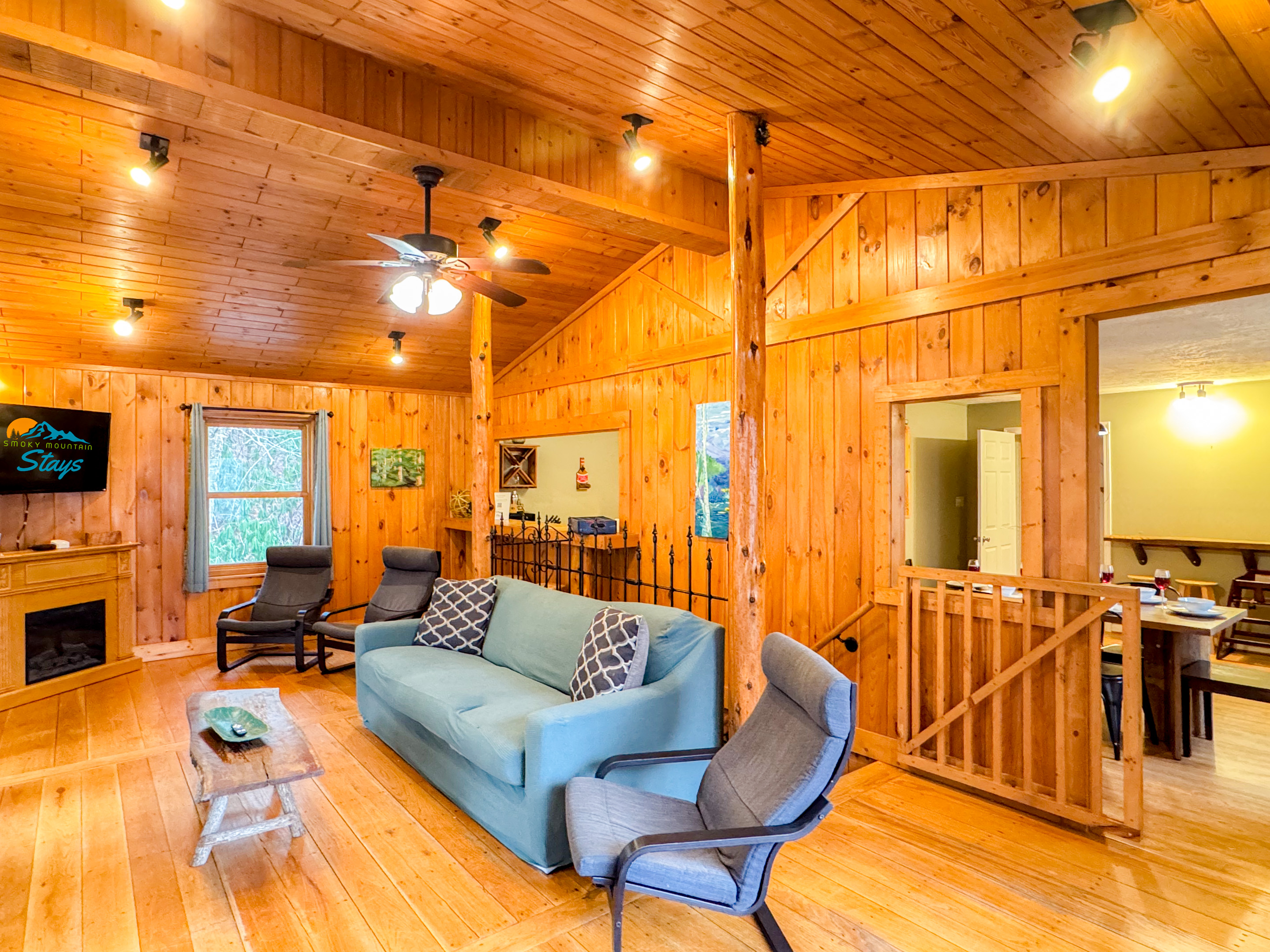 our cozy living room complete with a 55" Smart TV, seating, games, and wonderful views!