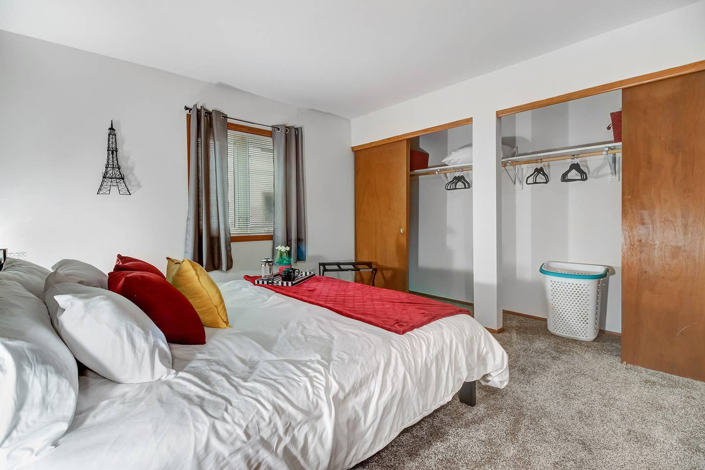 Black out Curtains on Bedroom Window.Luggage rack and velvet hangers in ample bedroom closet space.