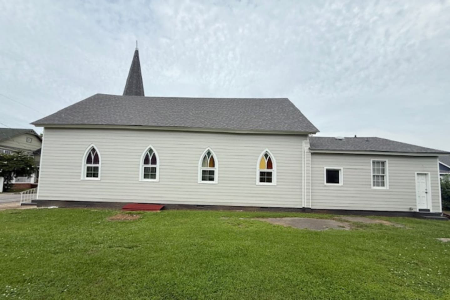 Beautifully restored chapel exterior featuring crisp white siding and a timeless steeple. Just a short drive to the Augusta Riverwalk, Broad Street dining, the James Brown Arena, and Augusta University. Ample parking is available on-site.