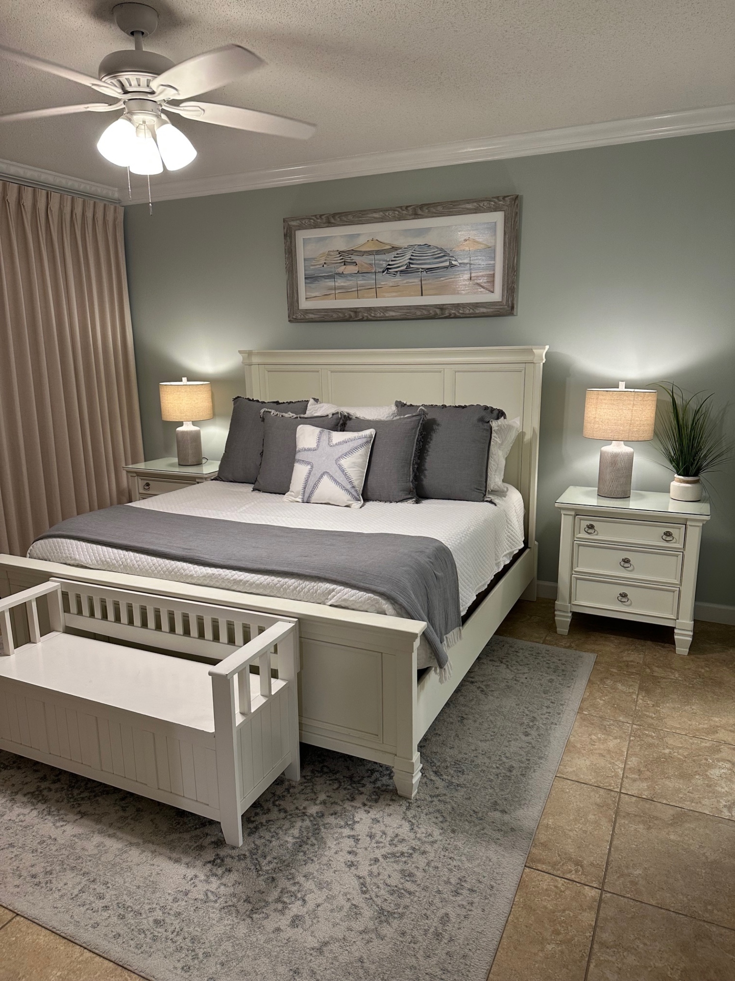 Master bedroom with king bed, ceiling fan, smart TV, clothing storage and ensuite bathroom