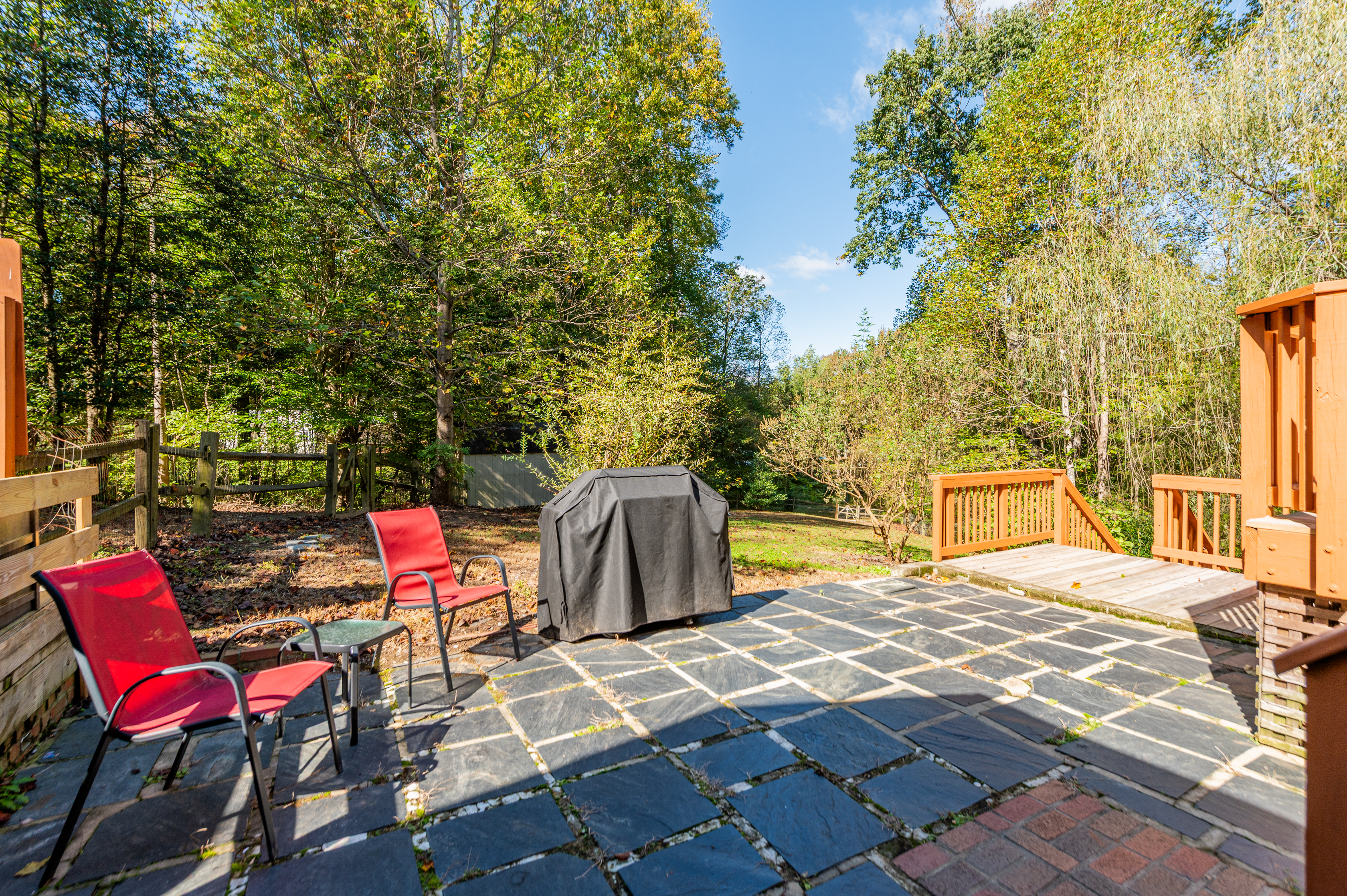Outdoor: Relax on the stone patio with grill, surrounded by lush greenery and sunshine!