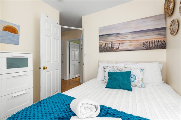 Rest easy on a comfy queen bed, bathed in natural light