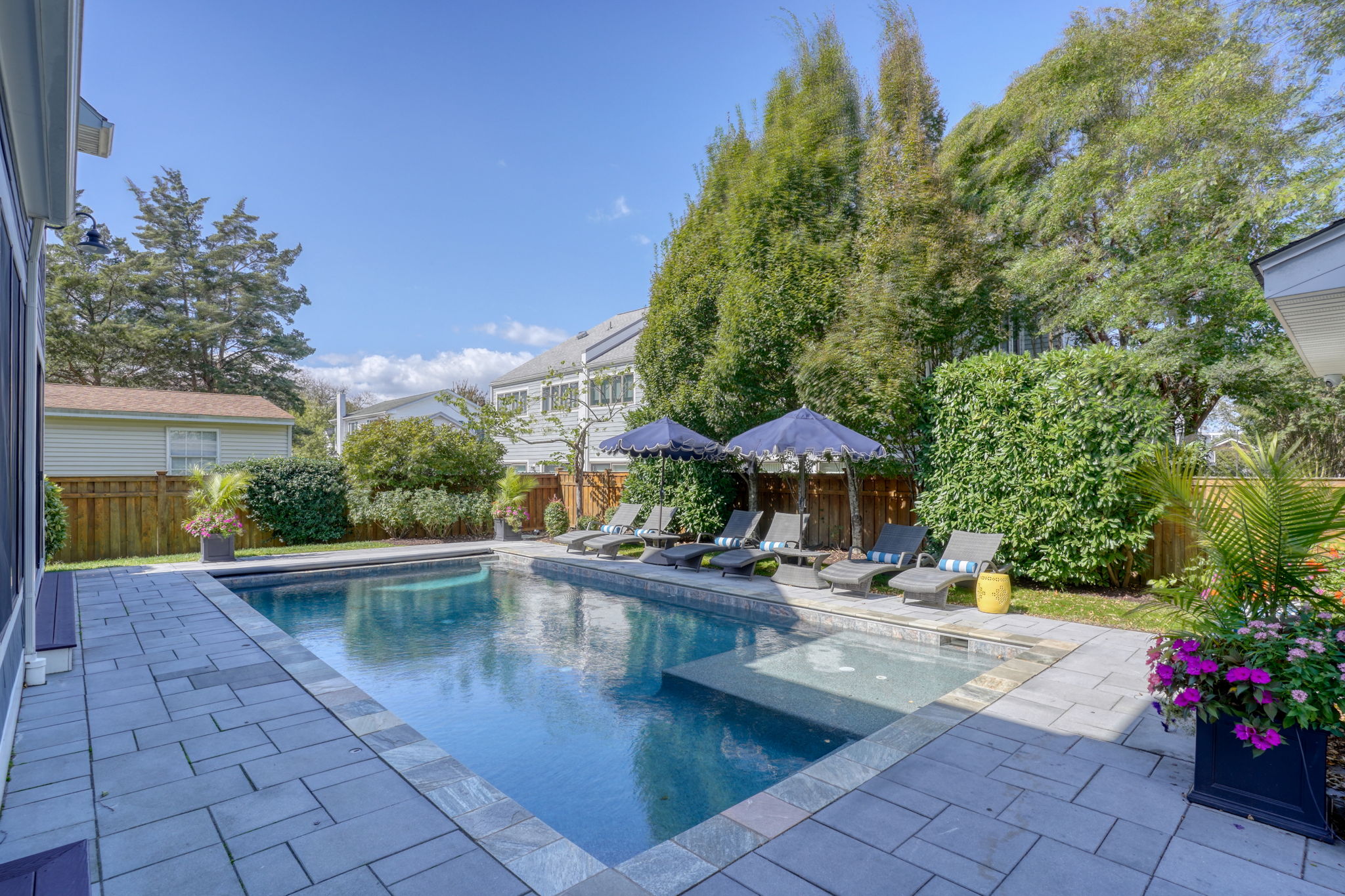 Resort-style loungers and lush landscaping