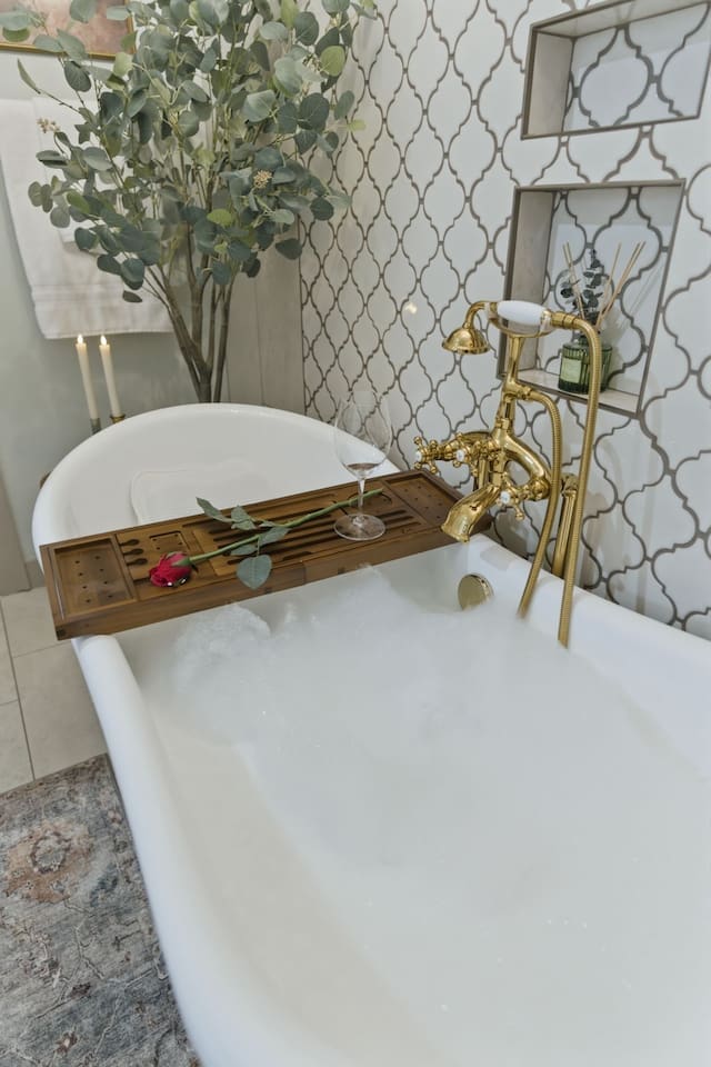 Luxurious soaking tub with elegant gold fixtures for a spa-like experience