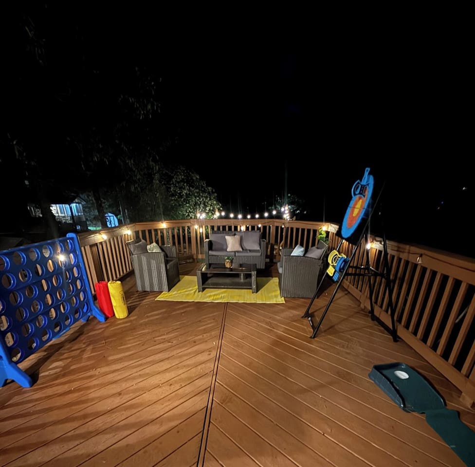 Cushioned seating, string lights, and oversized Connect 4 make this deck a favorite for evening hangouts. 
