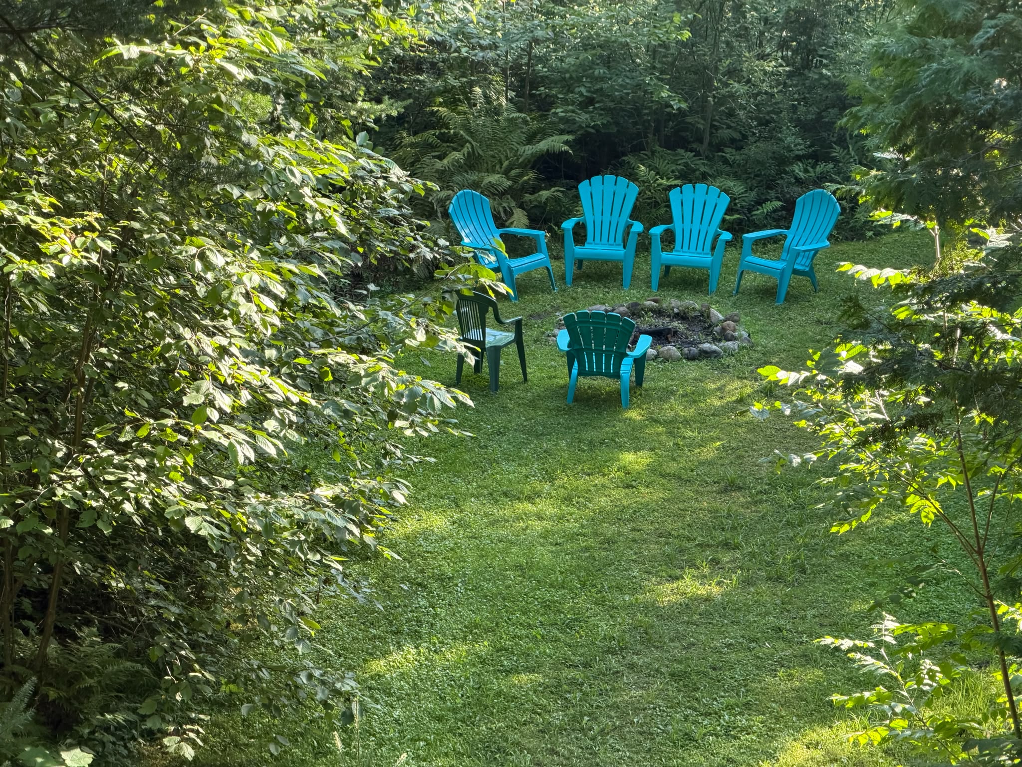 Seating around fire pit close to lake's edge