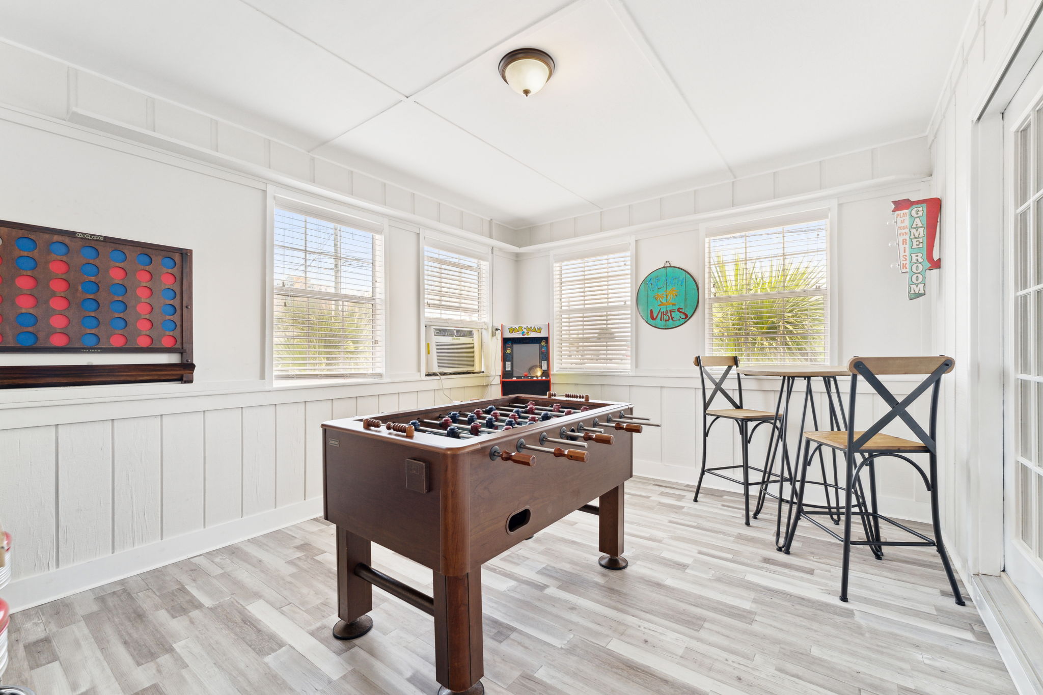 Step up your game night with this epic beach house game room! Get ready for a connect 4 showdown or blast through classic arcade games. #GameOn