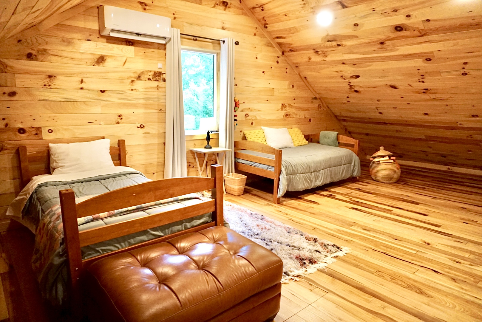 Attic Retreat: Bright wood accents and comfy beds create the perfect mountain getaway!