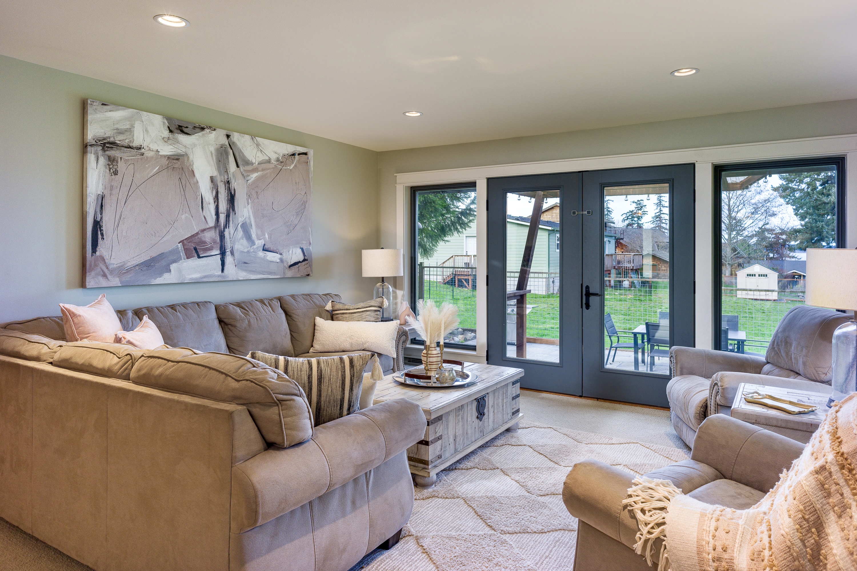 Straight out of this absolutely cozy living room you can enter on to the patio. The living room has peek-a-boo views of the water that awaits you.