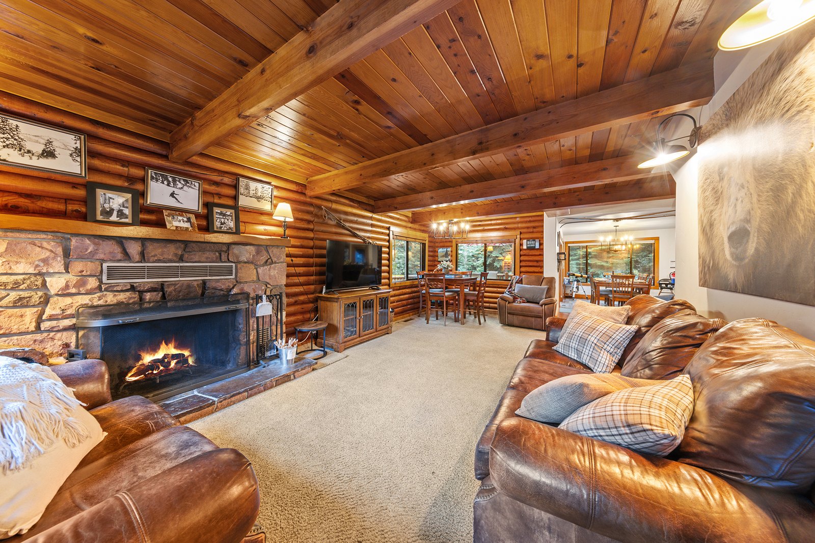Light the wood-burning fireplace and settle in under the log beams, the kitchen and dining just a few steps away.