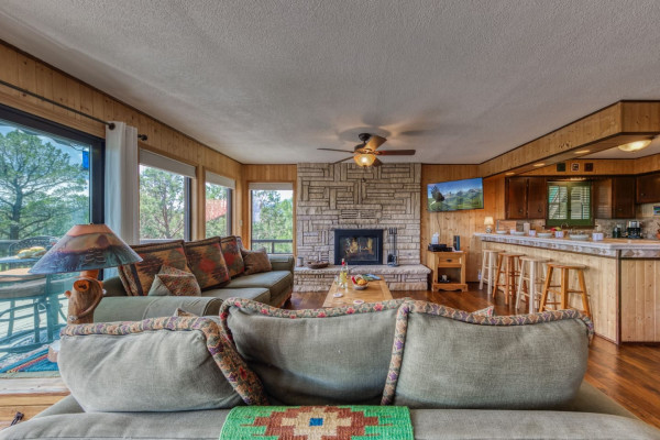 Relax in the cozy living room, featuring a comfortable couch and a warm fireplace — the perfect space to unwind and enjoy a quiet moment