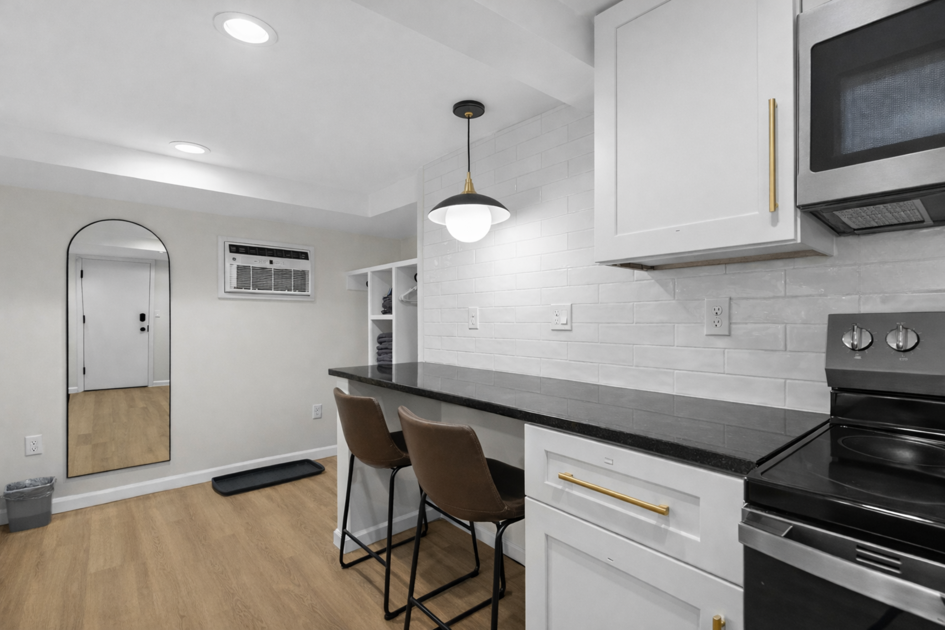 Modern kitchen and dining nook with sleek appliances, bar seating, and stylish finishes—perfect for casual meals, coffee mornings, or winding down after the day.