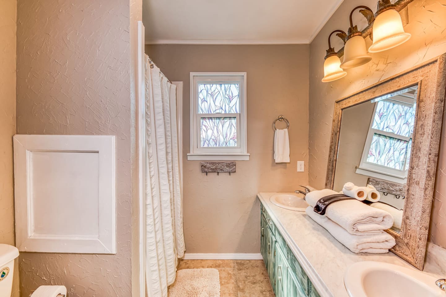 Luxury Bathroom: Elegant dual sinks & natural light create a refreshing retreat after beach fun!