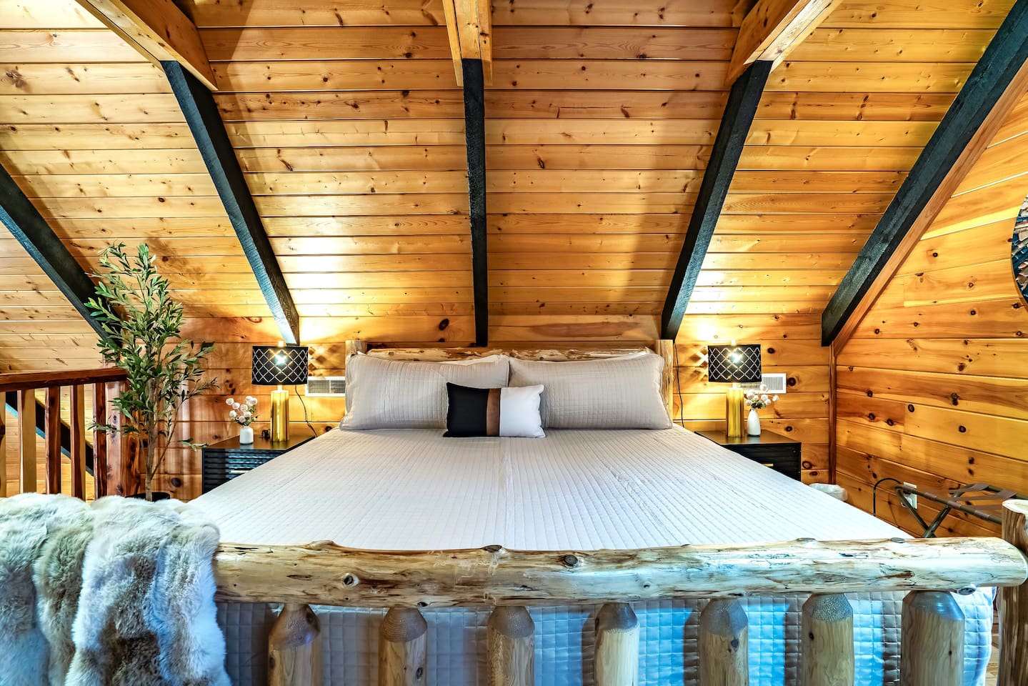 Inviting loft retreat with king-size bed in a contemporary mountain cabin, ideal for couples, friends, or family seeking comfort and scenic views.