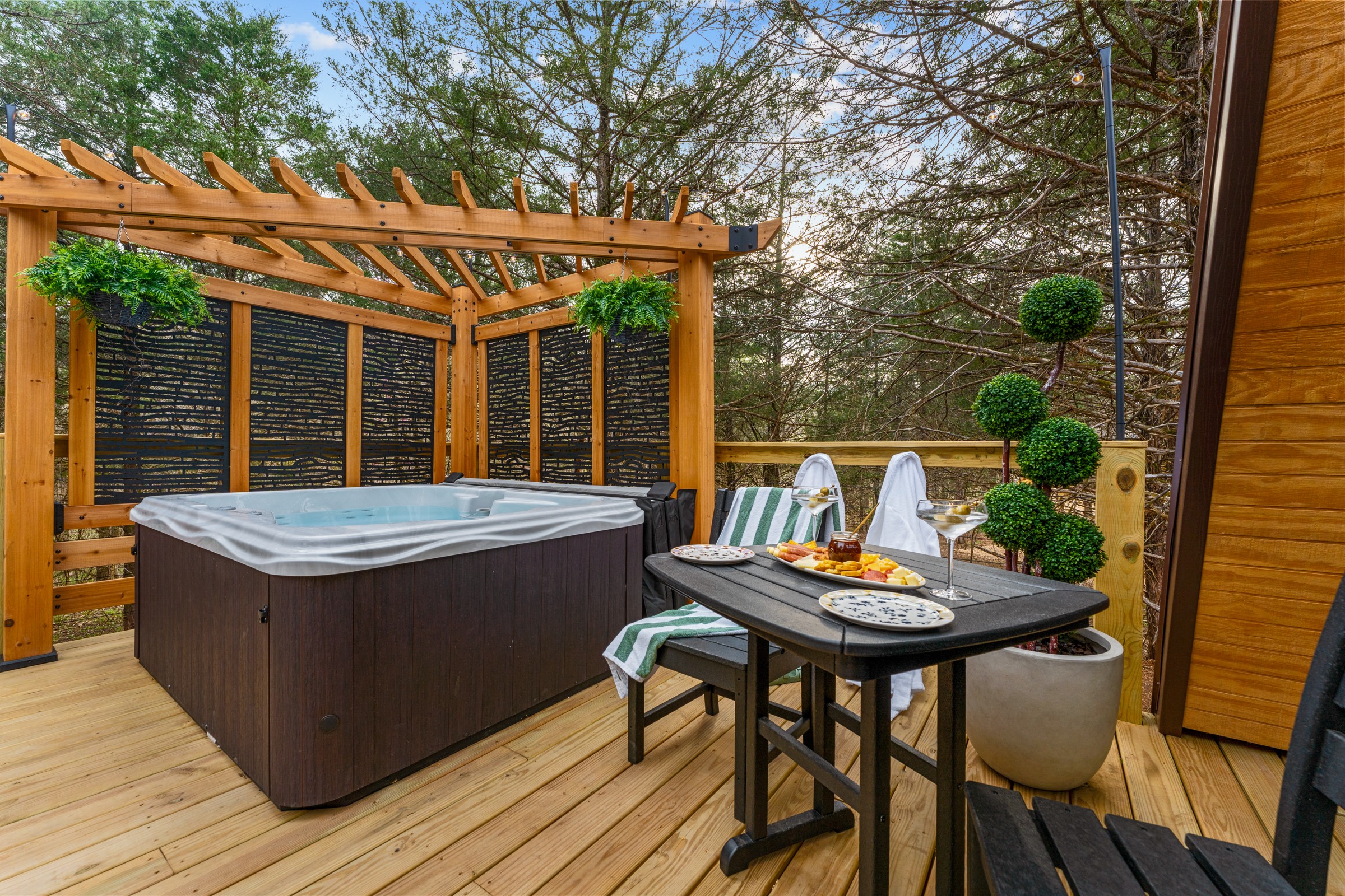 Hot tub, charcuterie and martinis on the deck table. Set the table, pour a drink and soak the evening away.