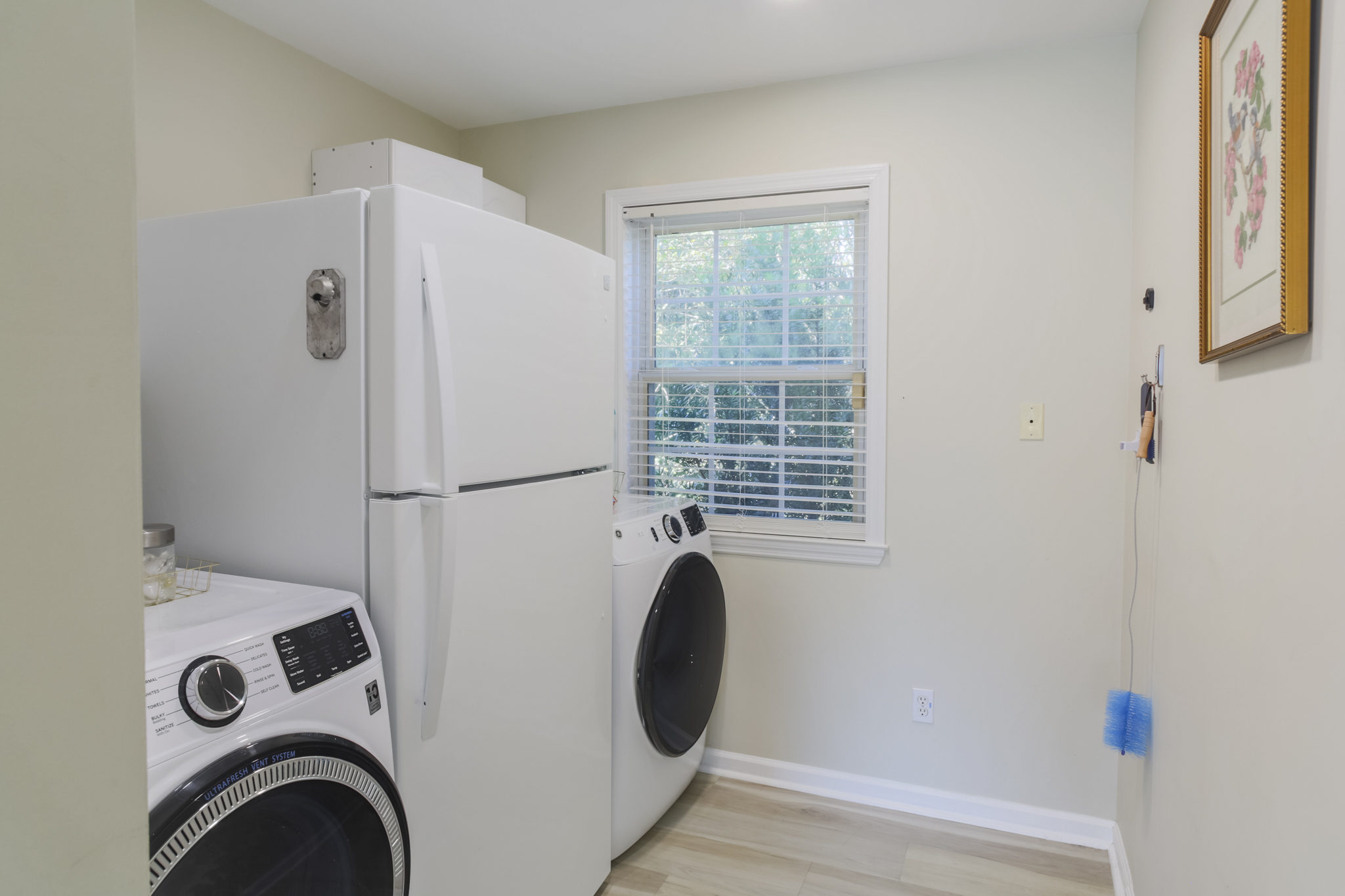 Convenient laundry room with washer, dryer, and an extra fridge for your stay.