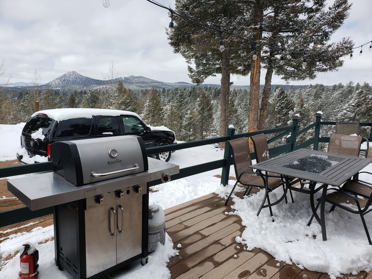 A propane grill with a view and a table setting for 6