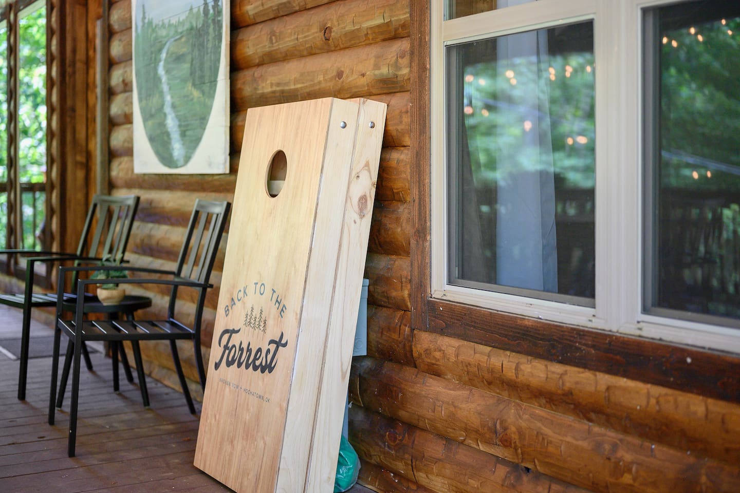 Enjoy sunny afternoons or evening games with family and friends on the backyard cornhole set—fun for all ages amidst serene forest surroundings.