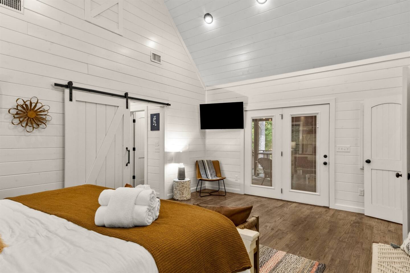 Wake up refreshed in a bedroom that blends rustic charm with modern luxury, tailored for a restful stay.

