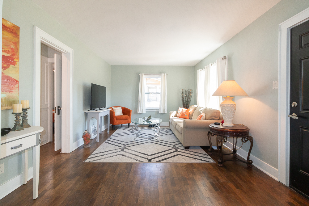 Bright and inviting living room with comfortable seating and a Smart TV.