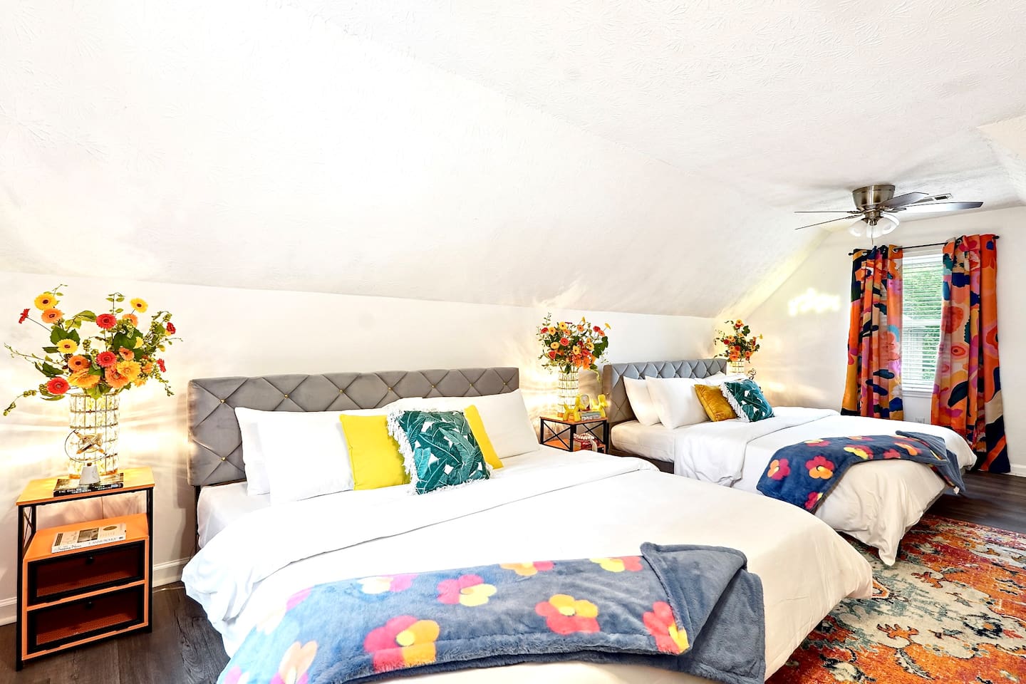 Bedroom 2 is located upstairs and features two king beds and a TV. This room does not have a private en-suite bathroom but has access to a shared full bathroom on the second floor.