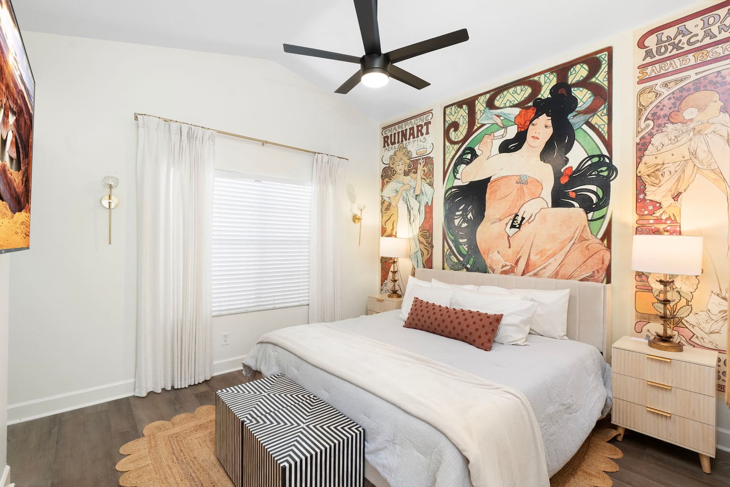 Curated primary bedroom with vintage art, soft linens, and warm lighting — a retreat within the retreat.