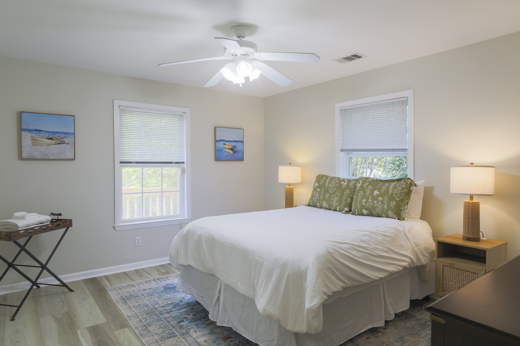Inviting second bedroom with plush bedding and plenty of natural light.