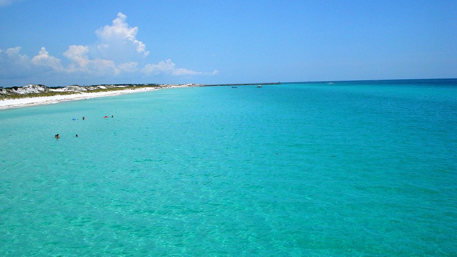 Endless turquoise water and untouched shoreline at Shell Island—a must-see, just minutes from your stay. 🏝️