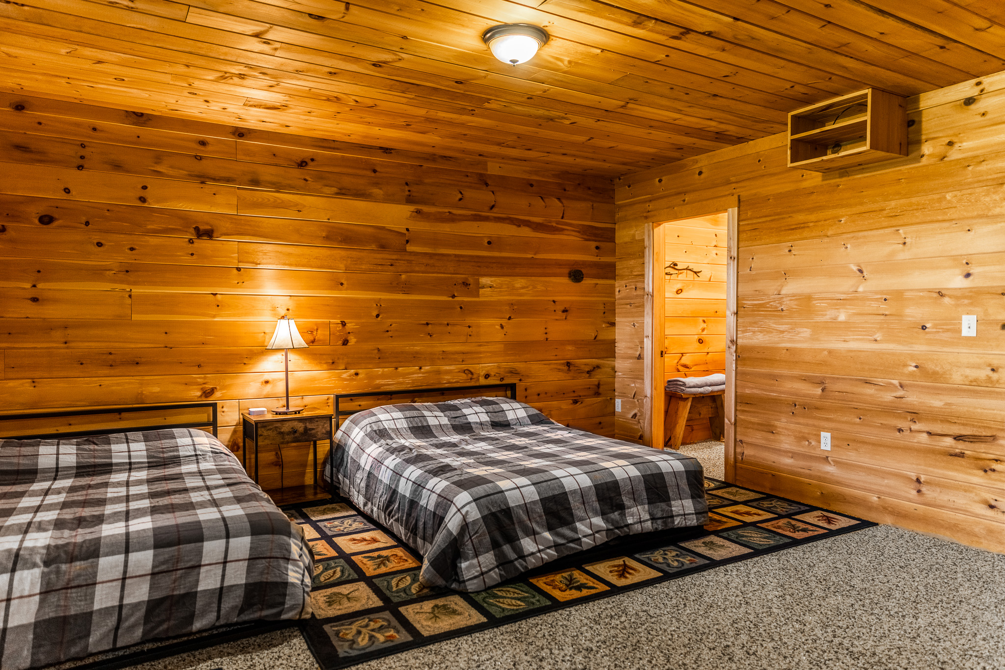 Enjoy the downs floor suite with views of the beautiful lake, a full attached bathroom, TV for streaming, clothing storage, and charger stations by 2 queen beds.