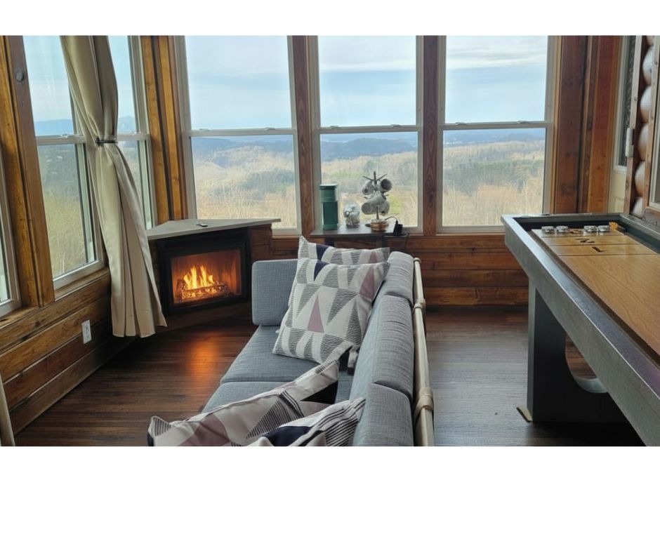 Enclosed deck featuring mountain views, seating area with electric fireplace (newly added!), coffee station and shuffleboard