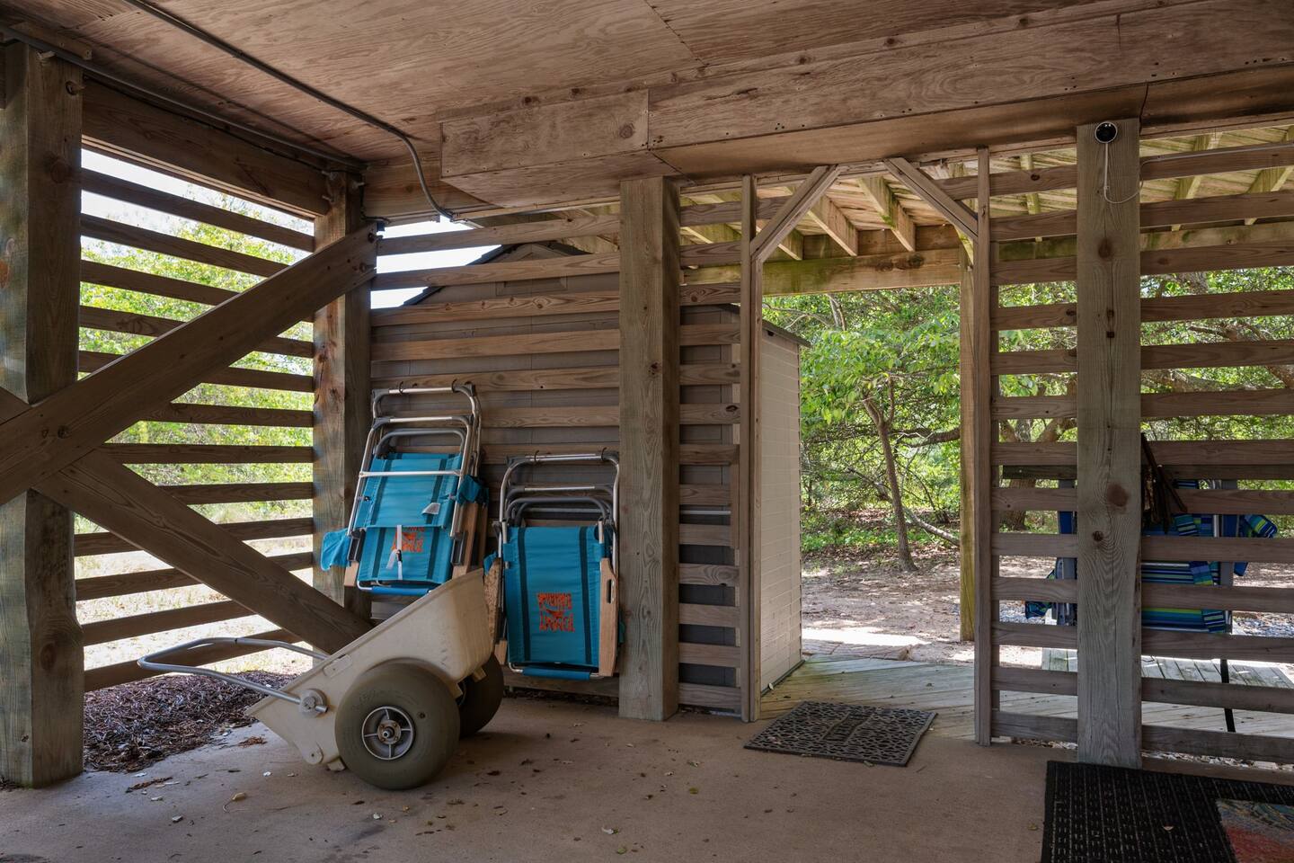 Beach gear and cart in carport