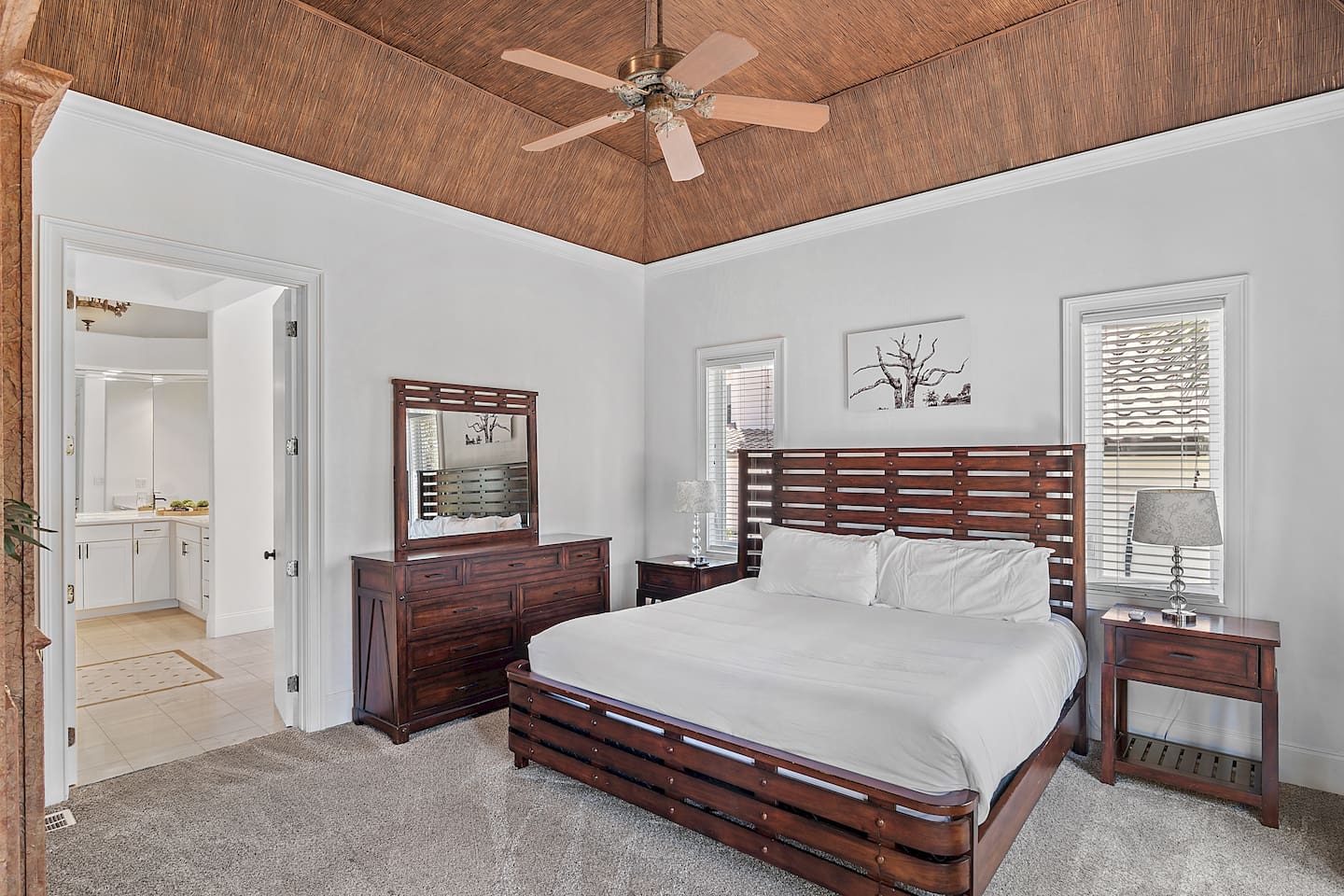 Primary suite featuring bamboo ceilings and custom tray lighting