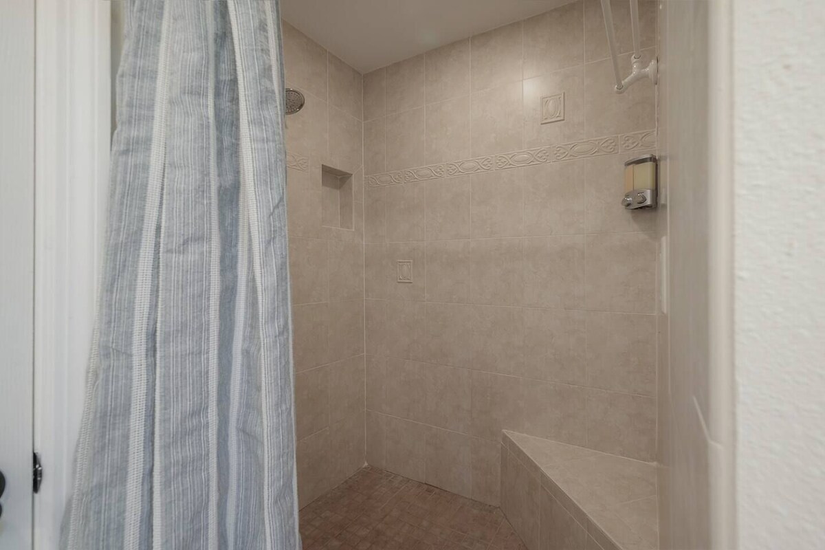 A practical shower design with a built-in niche and seating area.