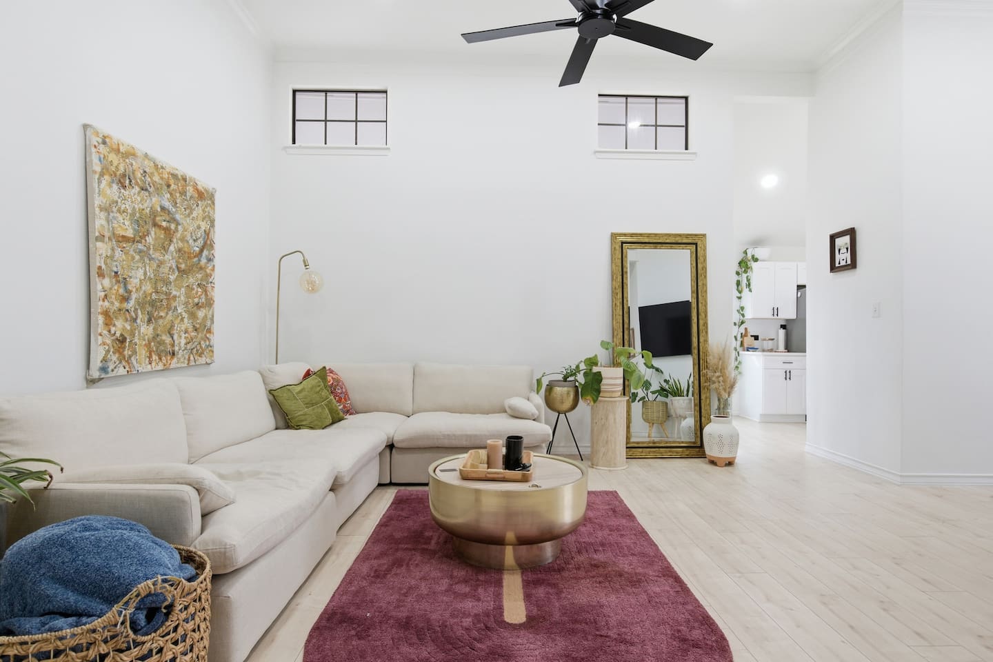 Spacious living area featuring Smart TV, plush sectional, modern coffee table, ceiling fan, and natural light — ideal for families, groups, and extended stays.