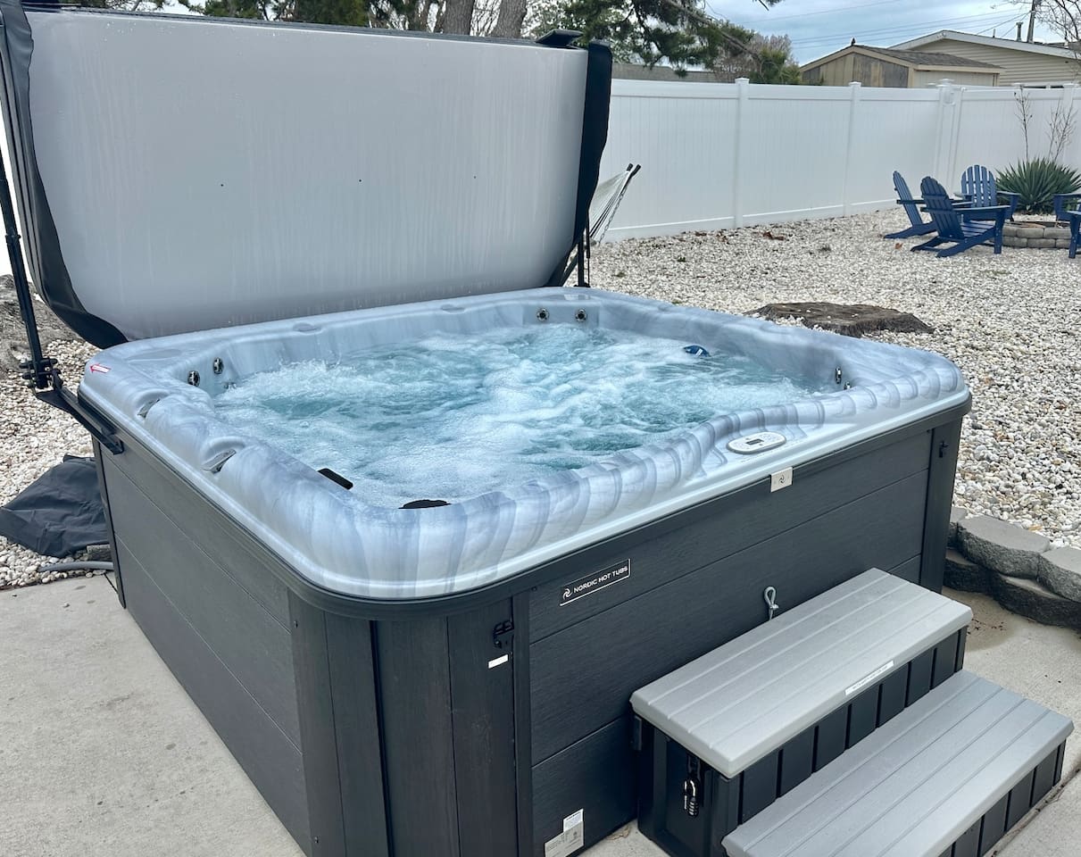 Unwind in our private hot tub, perfectly situated for stargazing. The fenced backyard also features a gravel lounge area with Adirondack chairs—the ultimate spot for evening relaxation and fresh air.