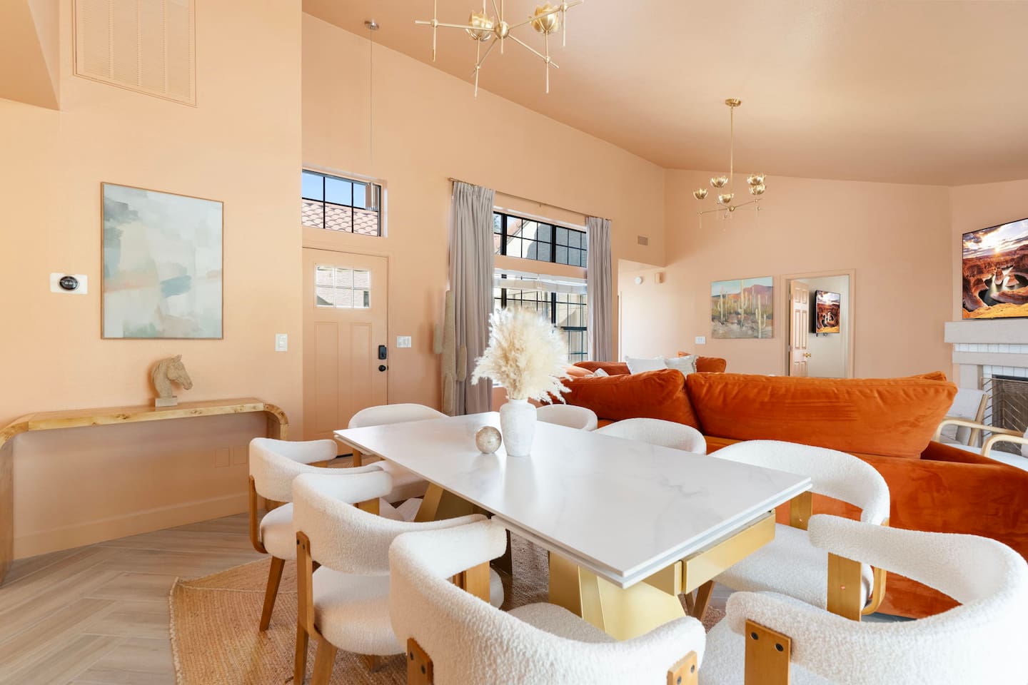 Sunlit open-concept living with marble dining, hardwood floors, and layered seating for every mood.