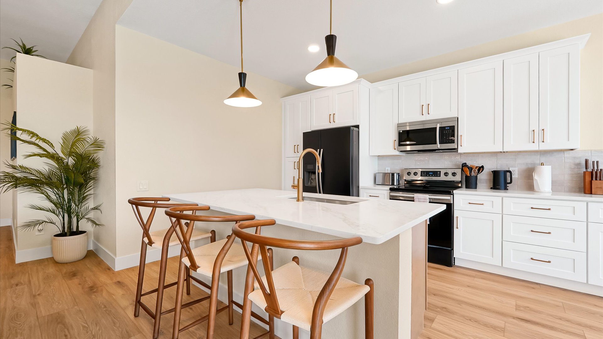 Kitchen: Fully renovated kitchen with a spacious island, seating for three, abundant cabinetry and modern appliances.