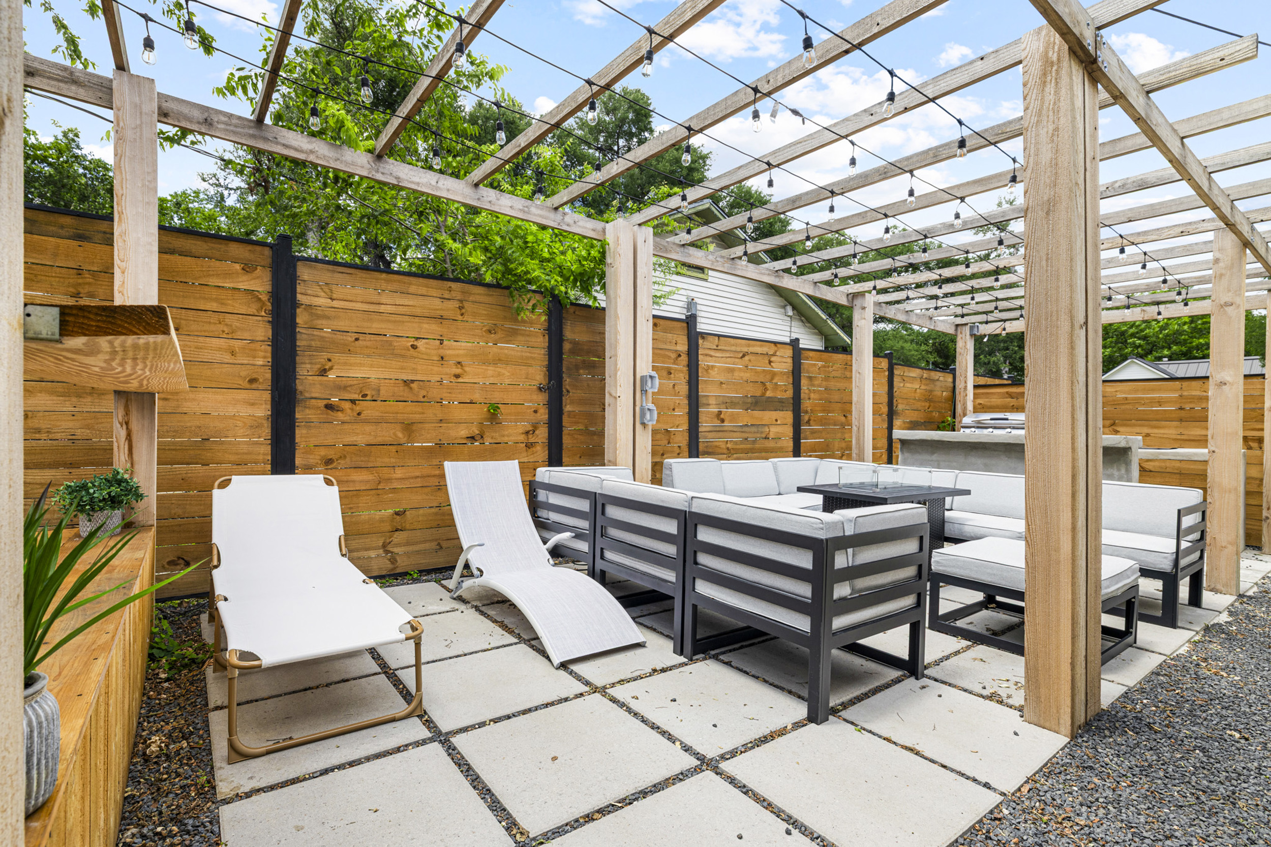 Relax in style with a hot tub, lounge chairs, and twinkling string lights!