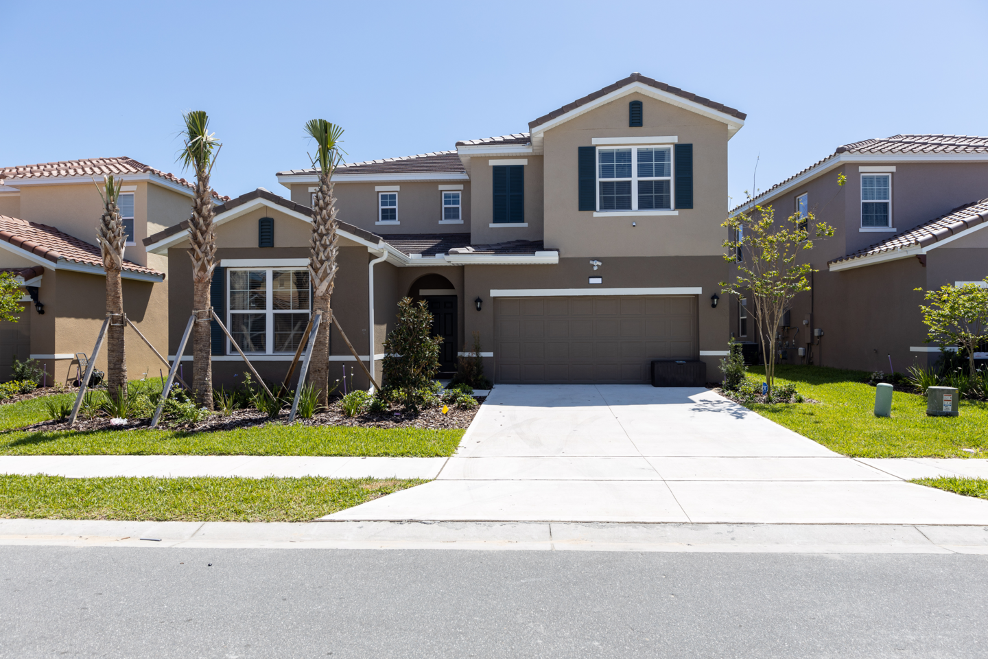 Front of 7 bedroom + 5 bathroom house. Empty garage + 2 parking spaces that can be double stacked for night parking. No overnight street parking allowed in community. 