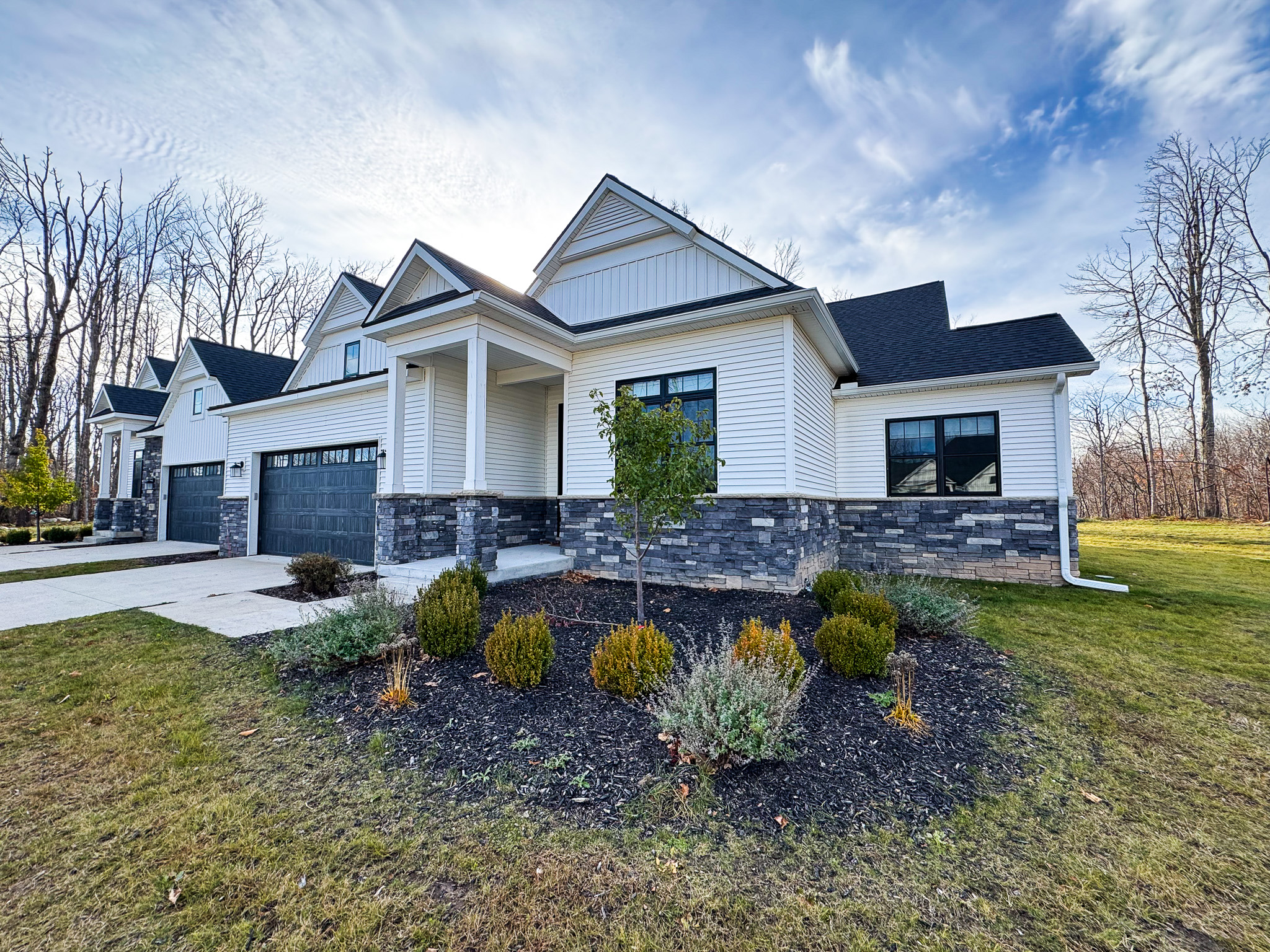 Perennial gardens surround the entry to this townhome.