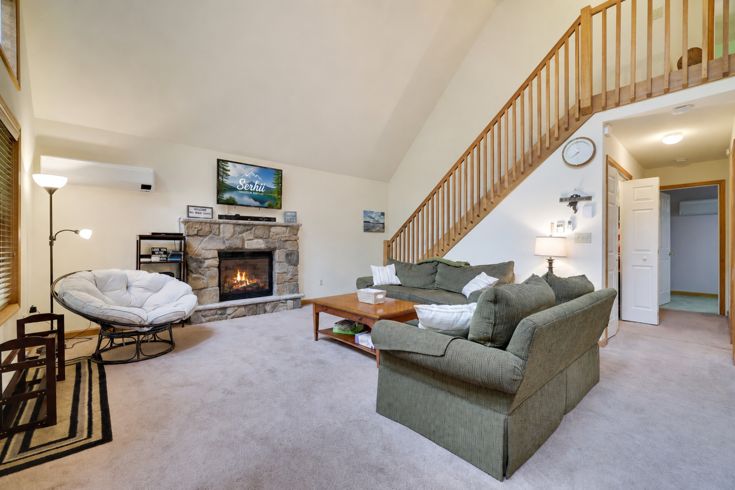 Living room with propane fireplace, comfortable couches, TV and coffee table