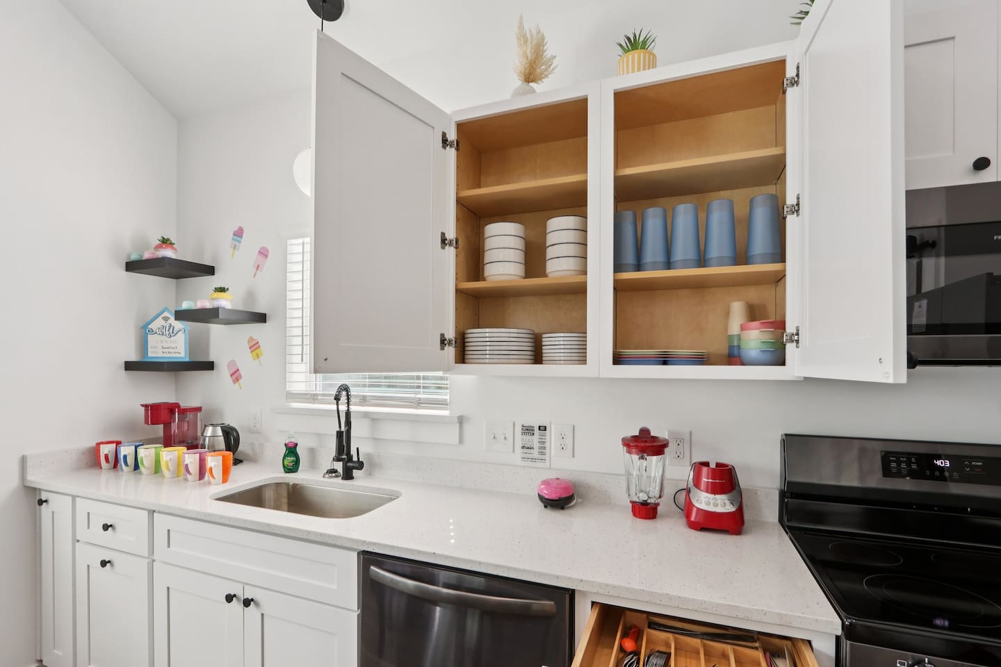 Coffee mugs with Keurig coffee maker (pods included), hot water heater, mini waffle maker, blender, stove, oven, dishwasher, fridge, filtered water, knives, cutting board, pots/pans, baking sheets, utensils.  